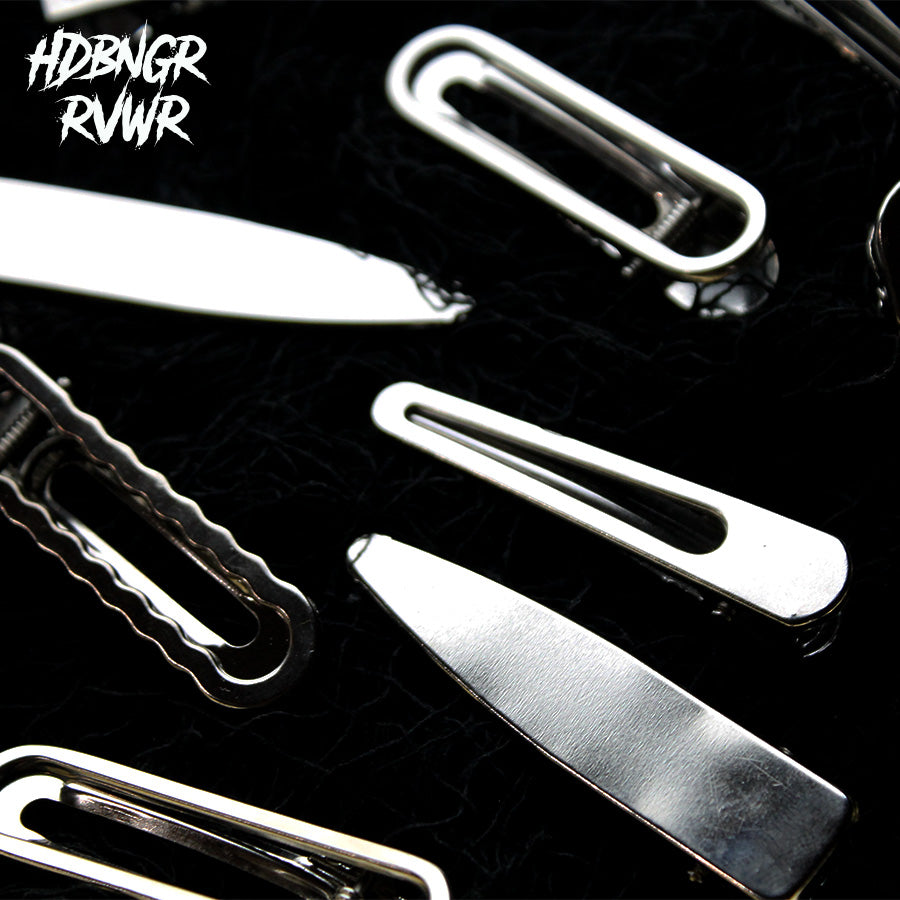Macro close-up of rounded silver open-oval hair clip edge on dark background — HDBNGR RVWR Y2K collection.
