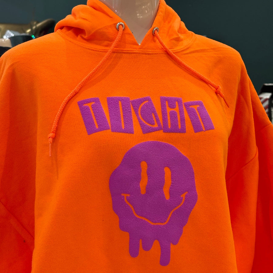 Orange hoodie with purple graphic design on a mannequin against a dark background