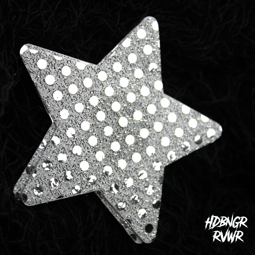Single silver sequin star-shaped pastie with mirror dot embellishment on dark textured background — Silver Stars by HDBNGR RVWR.