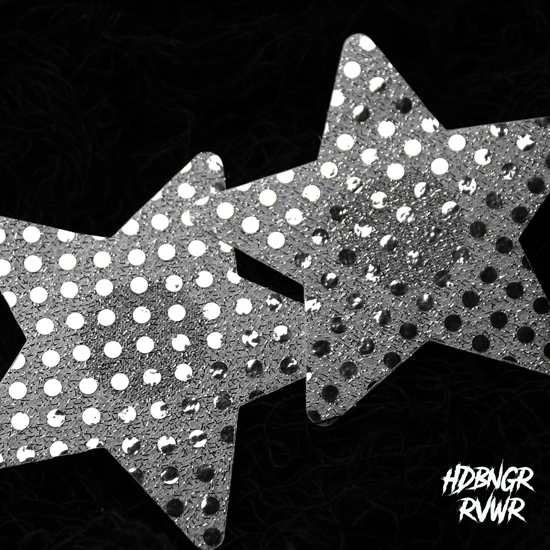 Pair of silver sequin star-shaped pasties overlapping on dark background — Silver Stars 2PC by HDBNGR RVWR.