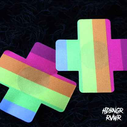 Pair of rainbow stripe cross-shaped pasties fanned out on dark background — Kiss the Rainbow 2PC by HDBNGR RVWR.