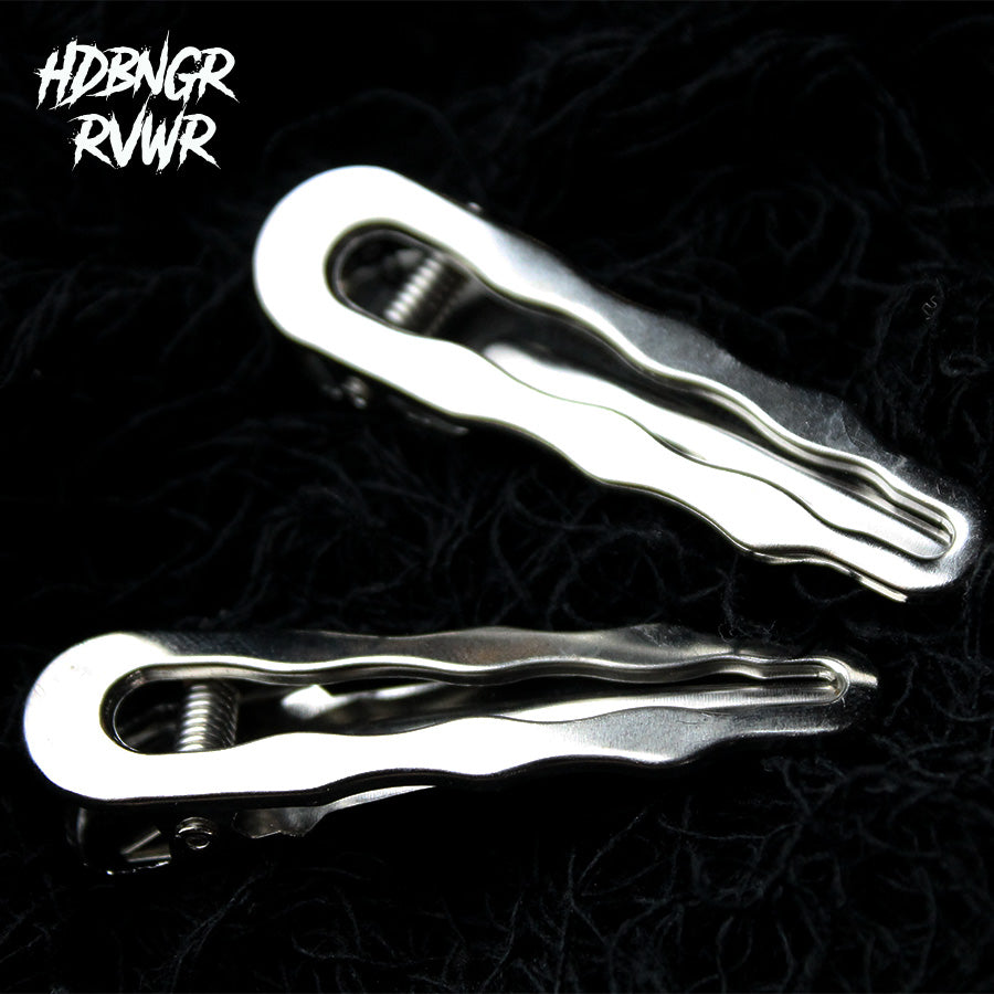 Two hair clips in silver and gunmetal wavy-edge finish on dark background — Abyss Waves V2 2PC Set by HDBNGR RVWR.