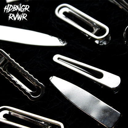 Macro close-up of rounded silver open-oval hair clip edge on dark background — HDBNGR RVWR Y2K collection.