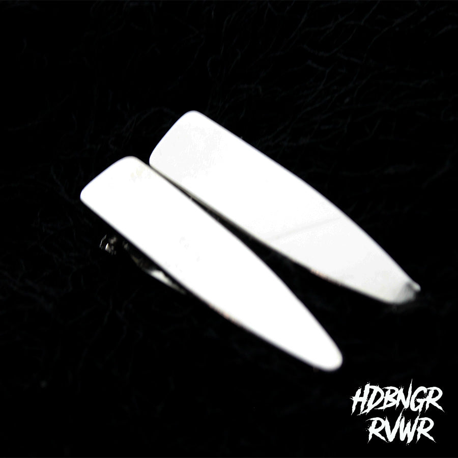 Close-up flatlay of multiple silver Y2K hair clip styles on dark background — HDBNGR RVWR group shot.