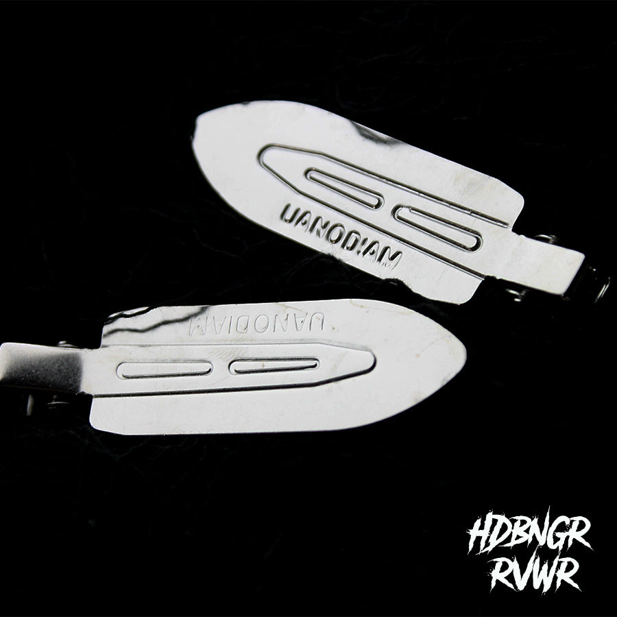 Flatlay of assorted silver Y2K hair clips on dark background including Minimal Metal style — HDBNGR RVWR collection.