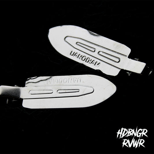 Flatlay of assorted silver Y2K hair clips on dark background including Minimal Metal style — HDBNGR RVWR collection.