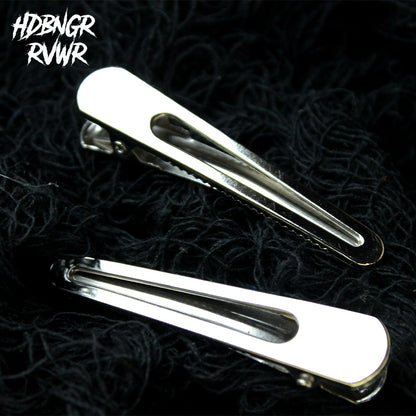 Two rounded open-oval silver hair clips on dark textured background — Y2K The Original by HDBNGR RVWR.