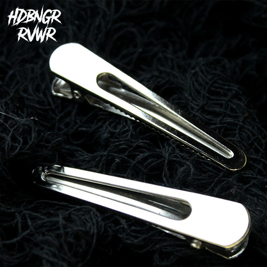Two rounded open-oval silver hair clips on dark textured background — Y2K The Original by HDBNGR RVWR.