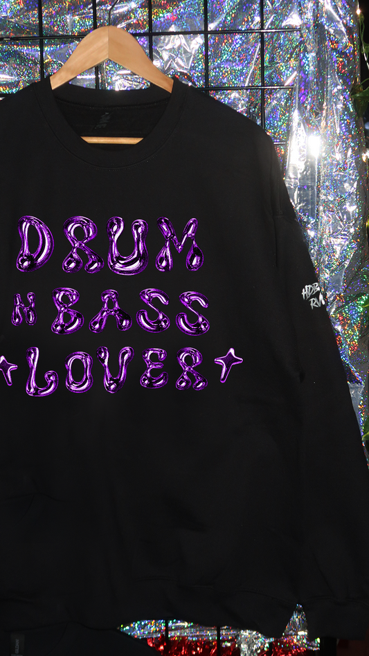 Black sweatshirt with purple text 'DRUM & BASS LOVER' on a reflective surface background