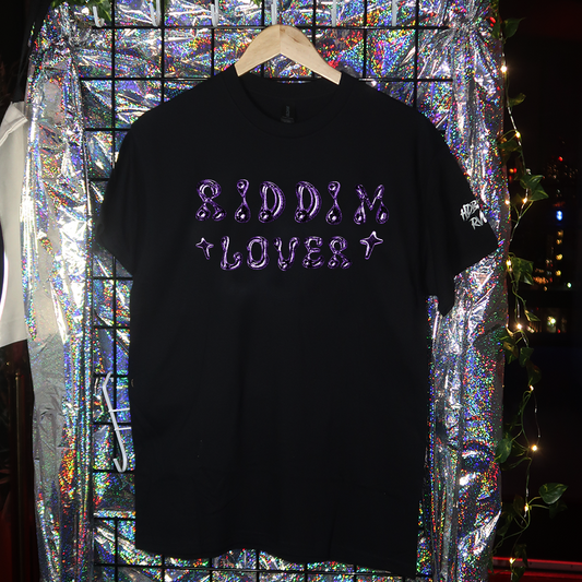 Black t-shirt with 'TECHNO LOVER' text on a hanger against a reflective, multicolored background.