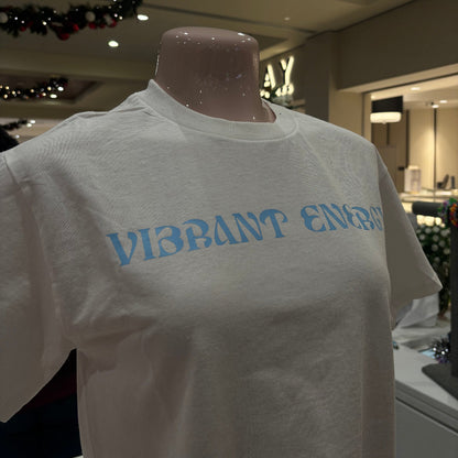 White t-shirt with blue text on a mannequin in an indoor setting
